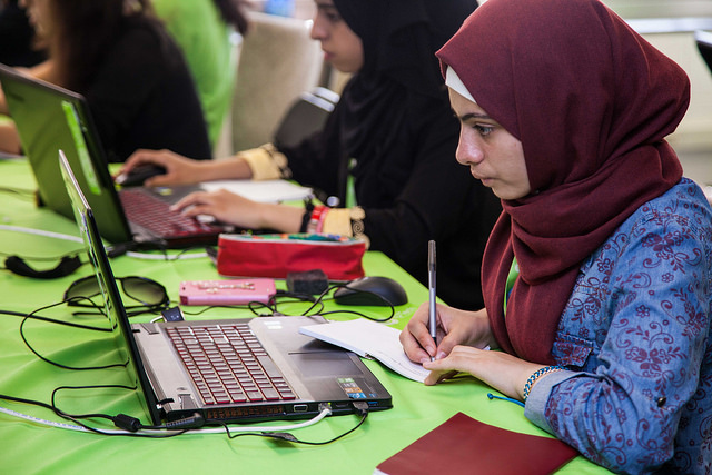 Muslim girl looking at laptop
