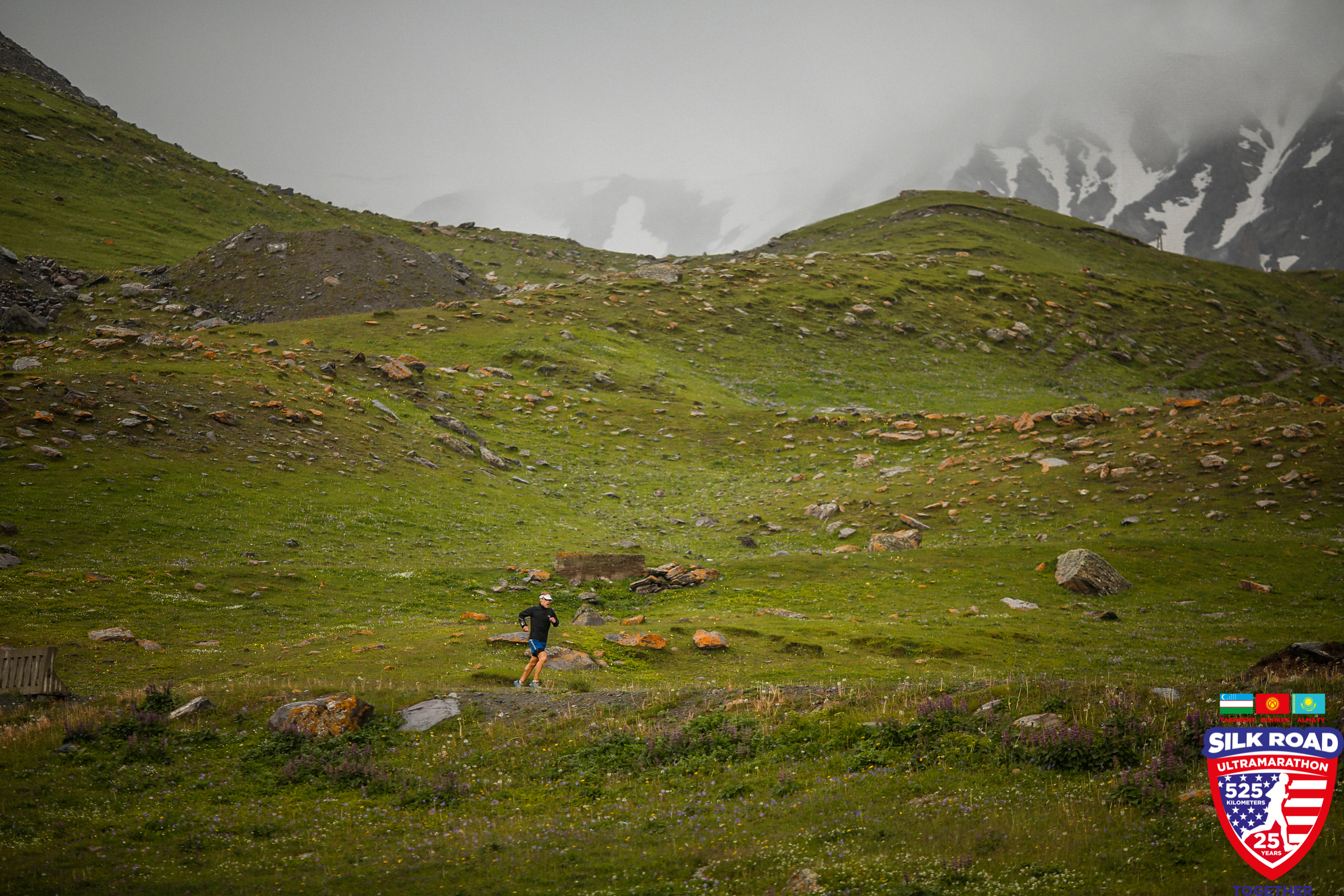 Dean runs through the rocky terrain of the misty Kyrgyz mountains 