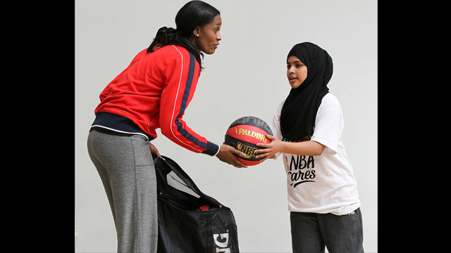 Swin Cash works with a teenage girl in London.