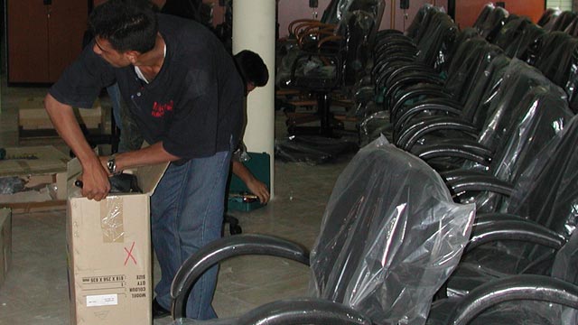 Iraq Museum staff assembles new office furniture supplied by the Department of State, July 2003