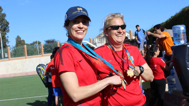 Kate and Linda displaying their Olympic gold medals.