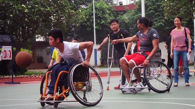 Students at Peiying Vocational School play wheelchair basketball with Sports Envoy Dr. Woodson-Smith.