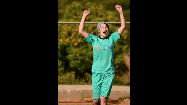 Moroccan clinic participant celebrates after winning a soccer match.