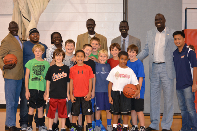 The South Sudanese coaches join a boy’s basketball team for practice at a local-area elementary school.