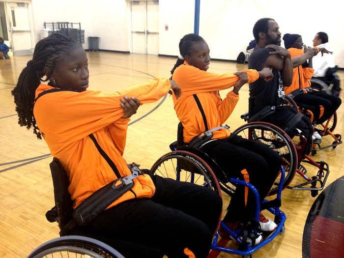 The Senegalese delegation stretches before participating in a disability sport activity with members of a wheelchair basketball league in Washington, D.C.