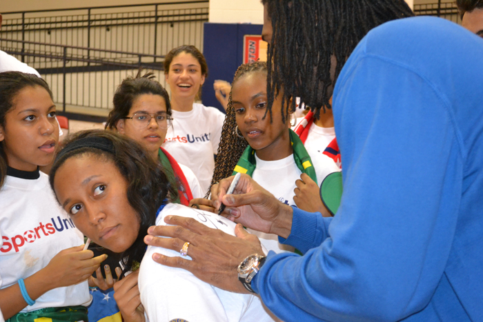 Nene Hilario—an Washington Wizards player from Brazil—signs autographs for the Brazilian youth basketball players.