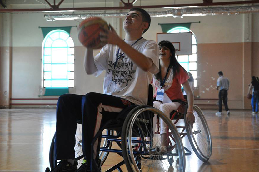 A youth participant goes for the shot during wheelchair basketball.