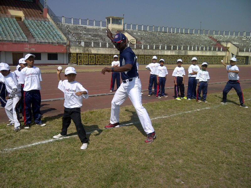 Joe Logan assists team members with their fast pitch.