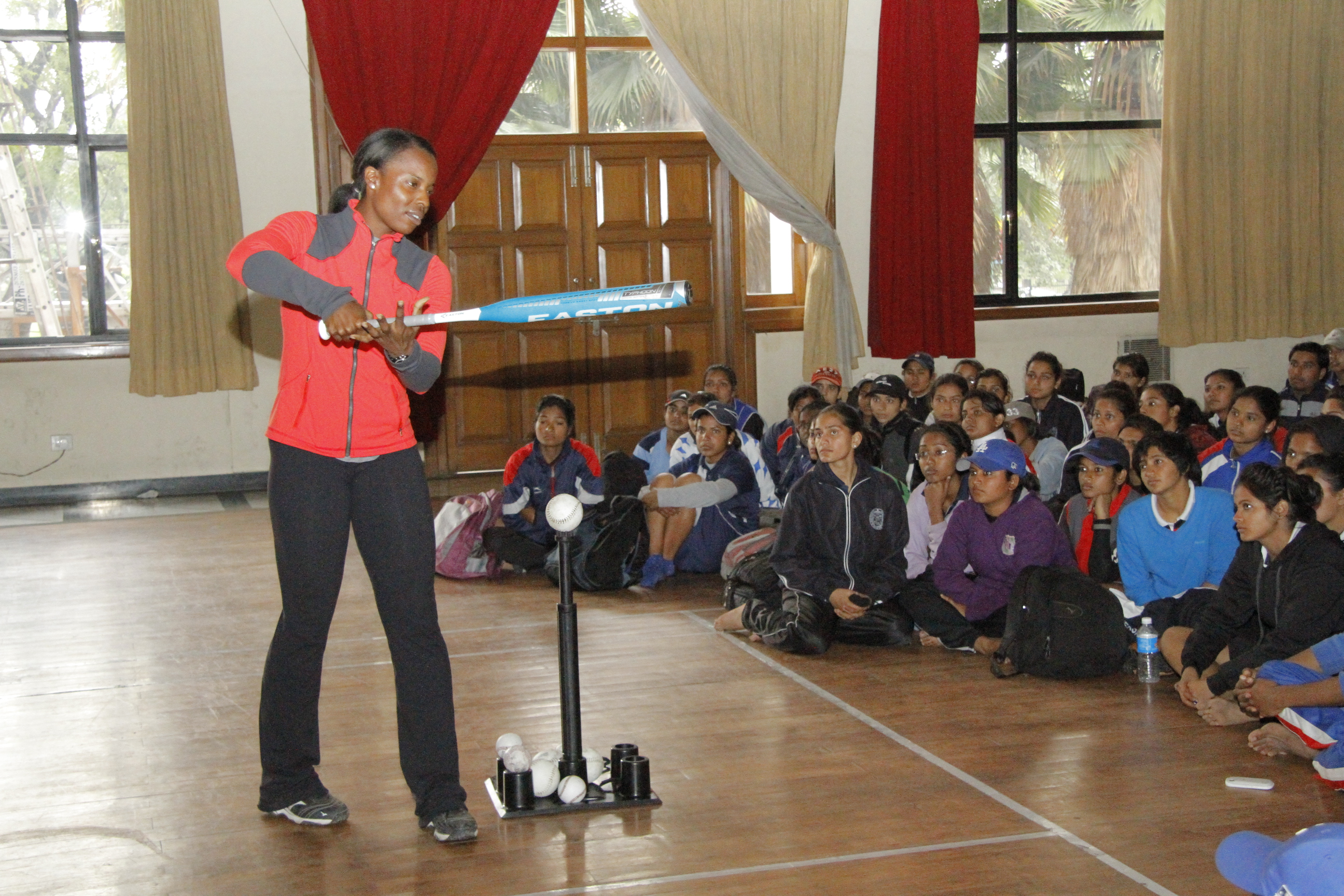 Sports Envoy Natasha Watley provides key tips on batting at a group meeting.   
