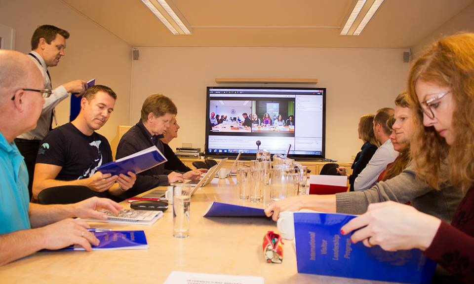 Participants sitting at presentation in conference room