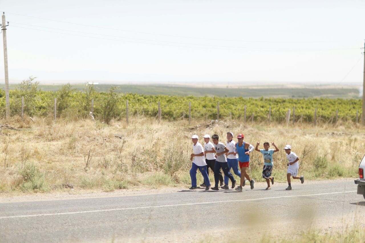 group running with Dean in countryside