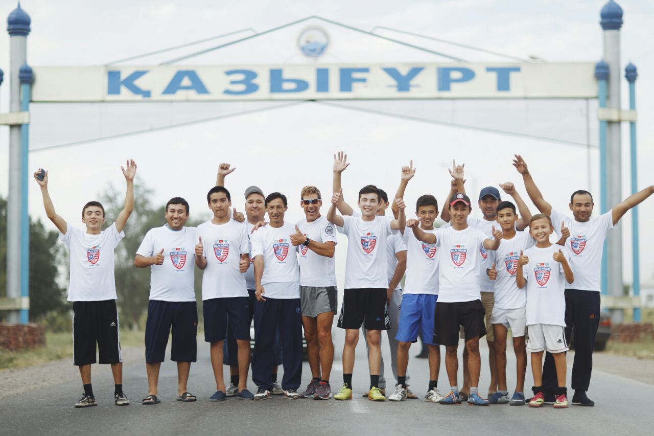 Dean Karnazes with group in front of location sign