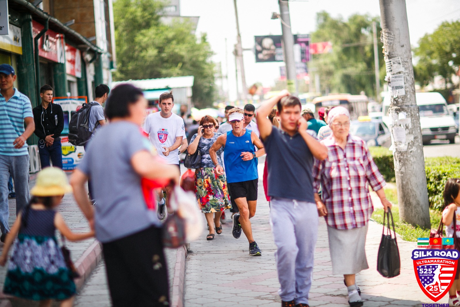 Man running through people on busy city sidewalk