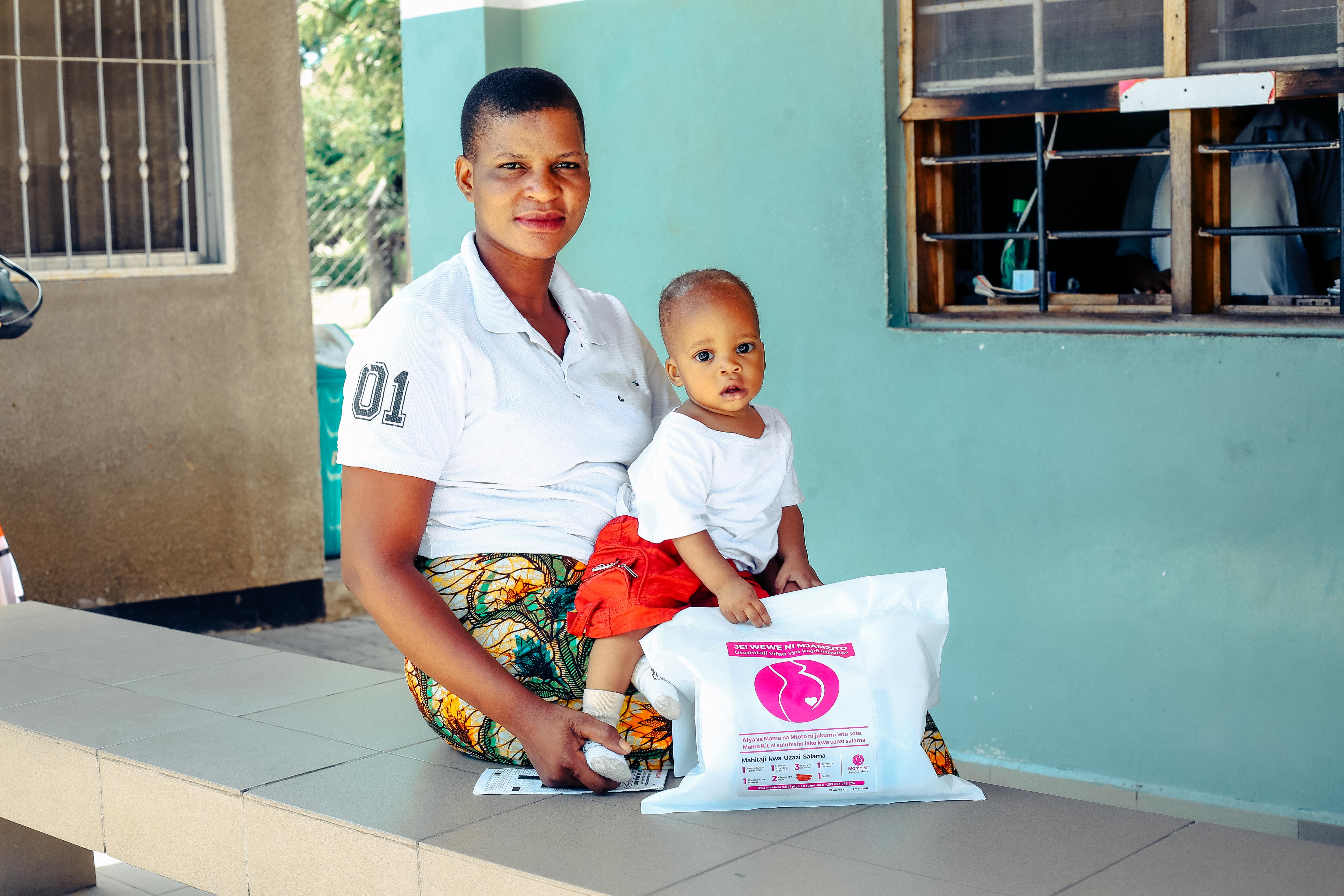 One mother smiles with the baby girl that she safely delivered - with the help of her Mama Kit.
