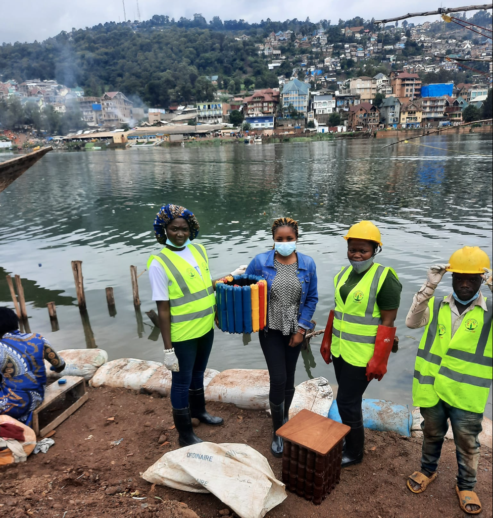 Nicole (second from left) with fellow Plastycor workers cleaning up waste at Lake Kivu in Bukavu, DRC