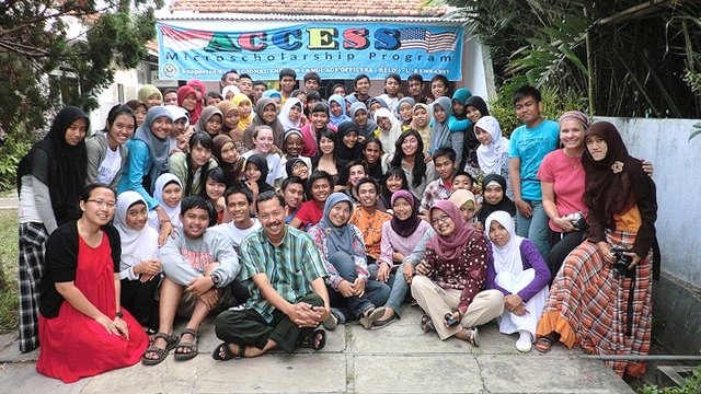 The group poses for a final photo in front of the school after their lessons.