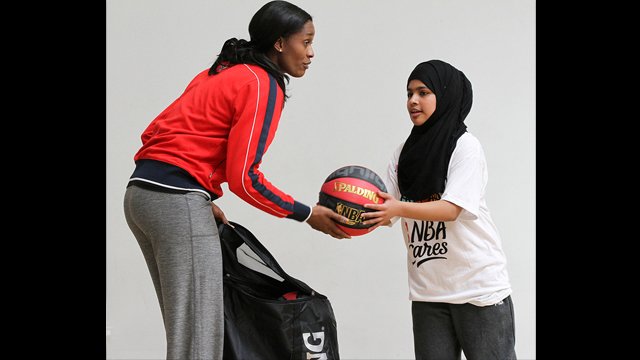 Swin Cash works with a teenage girl in London.