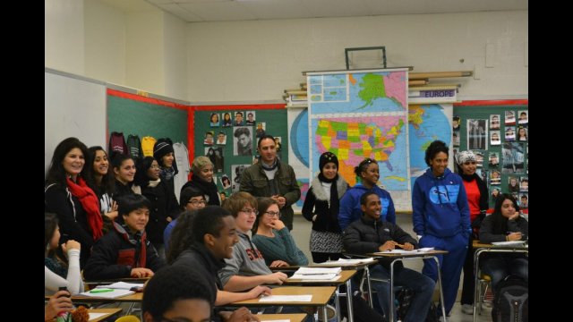 The group attends a high-school history class to learn about the U.S. school system.