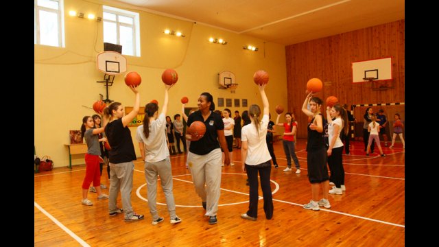 The girls basketball team works with Tamika Raymond on drills and skills.
