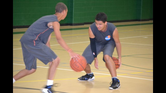 The Brazilian youth basketball players practice dribbling while warming up for a full-day of basketball clinics.
