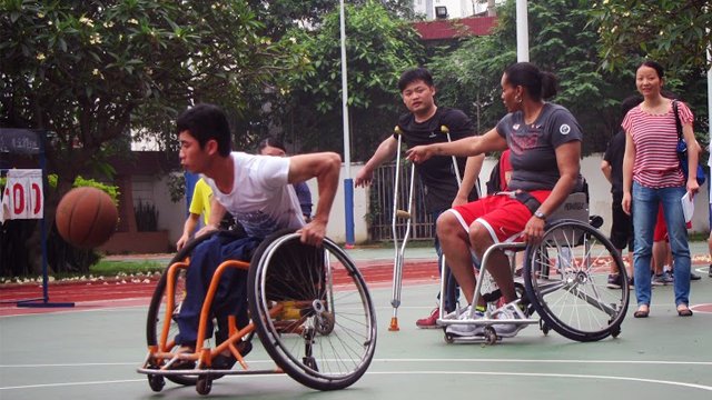 Students at Peiying Vocational School play wheelchair basketball with Sports Envoy Dr. Woodson-Smith.