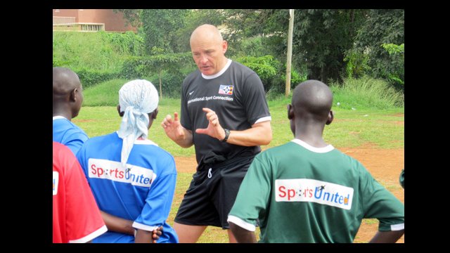 Ian Barker, head men's soccer coach at Macalester College, discusses training with Ugandan coaches.
