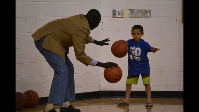 One of the coaches from South Sudan works on dribbling drills with a young athlete in Washington, D.C.