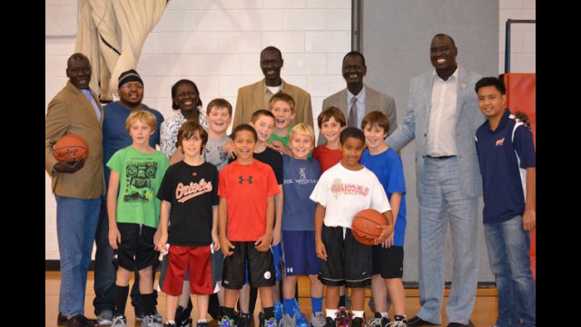 The South Sudanese coaches join a boy’s basketball team for practice at a local-area elementary school.