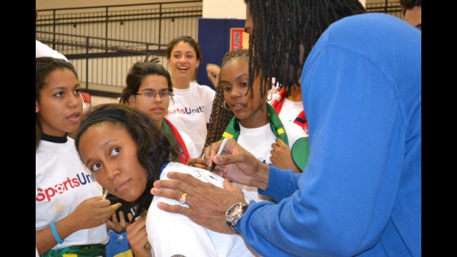 Nene Hilario—an Washington Wizards player from Brazil—signs autographs for the Brazilian youth basketball players.