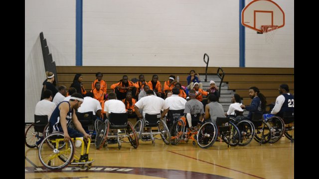 The young women have their first experience playing wheelchair basketball to learn about sports opportunities for people with disabilities.