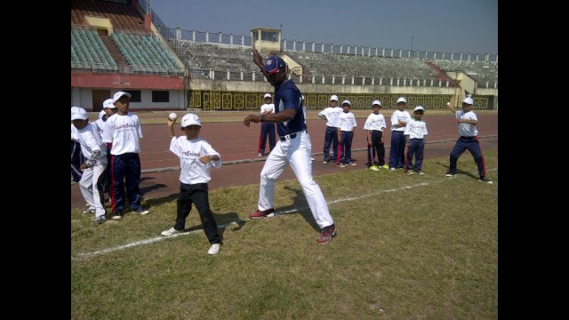 Joe Logan assists team members with their fast pitch.