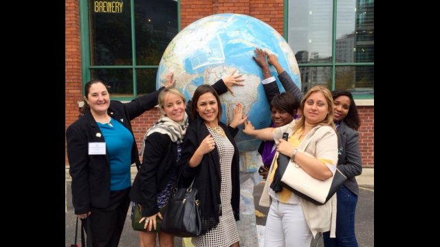 Group of young women touching large globe