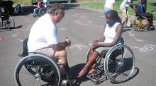 YES student Stella Tiyoy from Kenya meets with a physical therapist and wheelchair user to discuss opportunities to participate in wheelchair sports in the United States.