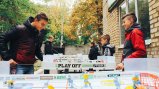 Two kids playing table hockey
