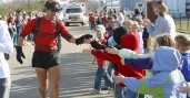 Dean Karnazes giving high five to kids while running