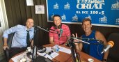 Dean behind the talk show microphones with the radio staff