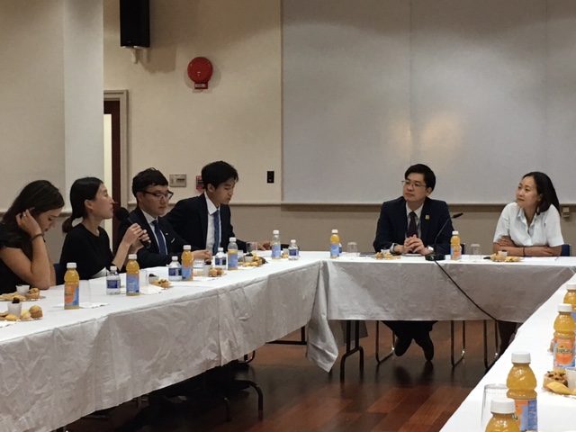 Group of young professionals sitting at a long table meeting